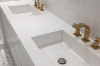 Photo of a mid-sized transitional master bathroom in Miami with flat-panel cabinets, white cabinets, an alcove shower, a one-piece toilet, white tile, marble, white walls, marble floors, an integrated sink, engineered quartz benchtops, white floor and a hinged shower door.