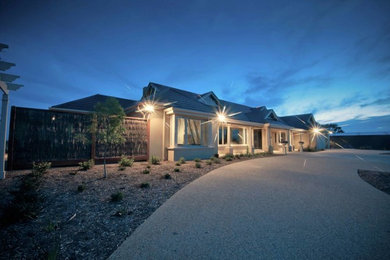 Inspiration for a large contemporary beige one-story concrete exterior home remodel in Melbourne
