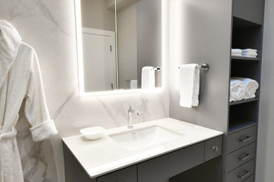 Bathroom - mid-sized modern master gray tile and mosaic tile laminate floor, gray floor and single-sink bathroom idea in Vancouver with flat-panel cabinets, black cabinets, gray walls, an undermount sink, granite countertops, white countertops, a floating vanity and a bidet
