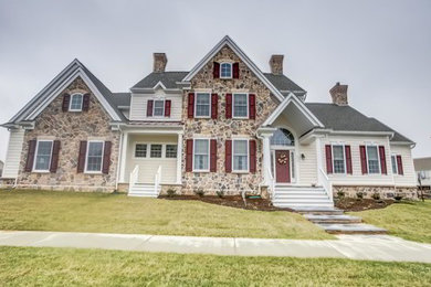 Large elegant beige two-story mixed siding gable roof photo in Philadelphia