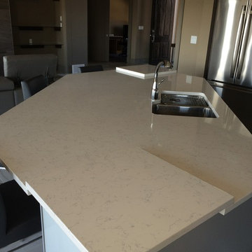 Quartz island with raised counters on edges to avoid seam