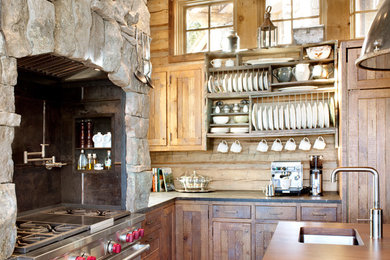 This is an example of a country kitchen in Other with stainless steel appliances.
