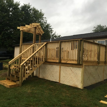 Small deck and decorative pergola; customer request of lattice under deck.