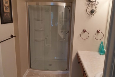 Inspiration for a small contemporary master beige tile and ceramic tile vinyl floor alcove shower remodel in Other with furniture-like cabinets, beige cabinets, beige walls and laminate countertops