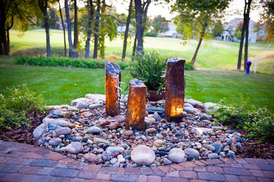 Design ideas for a mid-sized traditional full sun front yard stone formal garden in Kansas City with a fire pit.