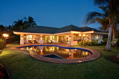 Inspiration for a mid-sized tropical backyard concrete and custom-shaped natural pool remodel in Hawaii