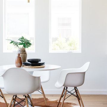 White Eames Molded Plastic Chairs and Saarinen Knockoff Table with Brass Pendant