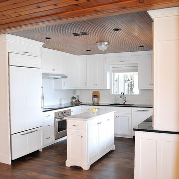 Left side perimeter featuring paneled refrigerator door and drawer with lift up