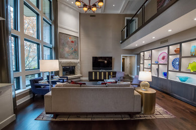 Living room - large transitional open concept dark wood floor and brown floor living room idea in Cleveland with beige walls, a corner fireplace and a stone fireplace