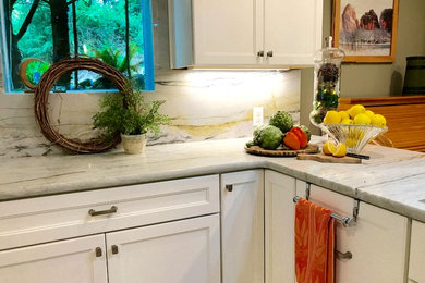 Eat-in kitchen - mid-sized transitional u-shaped vinyl floor and gray floor eat-in kitchen idea in Portland with a farmhouse sink, shaker cabinets, white cabinets, marble countertops, white backsplash, marble backsplash, stainless steel appliances, two islands and white countertops