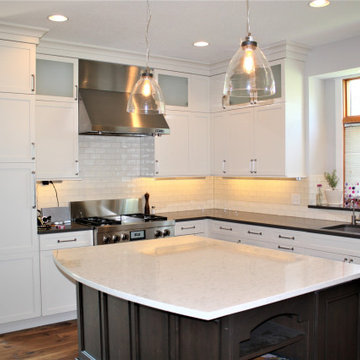 Floor To Ceiling Cabinetry With Stained Island
