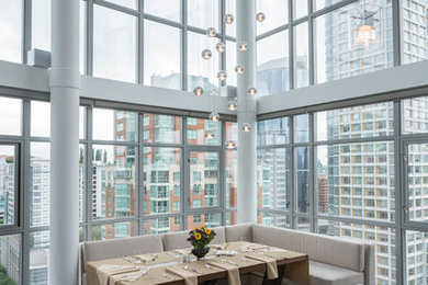 Kitchen/dining room combo - mid-sized modern dark wood floor kitchen/dining room combo idea in Vancouver with white walls and a standard fireplace