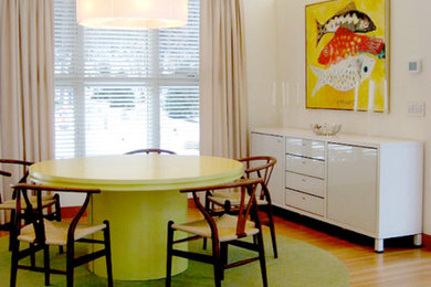 Mid-sized medium tone wood floor enclosed dining room photo in New York with white walls
