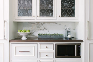 Inspiration for a large transitional galley dark wood floor eat-in kitchen remodel in Chicago with an undermount sink, beaded inset cabinets, white cabinets, marble countertops, white backsplash, stone slab backsplash, stainless steel appliances and an island