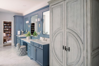 Bathroom - large french country master white tile and marble tile marble floor, white floor and double-sink bathroom idea in Atlanta with recessed-panel cabinets, blue cabinets, gray walls, an undermount sink, quartz countertops, a hinged shower door, white countertops and a built-in vanity