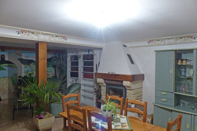 Cette photo montre une salle de séjour chic ouverte avec un mur gris et une cheminée standard.