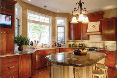 Open concept kitchen - mid-sized traditional l-shaped medium tone wood floor open concept kitchen idea in Orange County with a single-bowl sink, shaker cabinets, medium tone wood cabinets, granite countertops, beige backsplash, stainless steel appliances, an island and stone tile backsplash