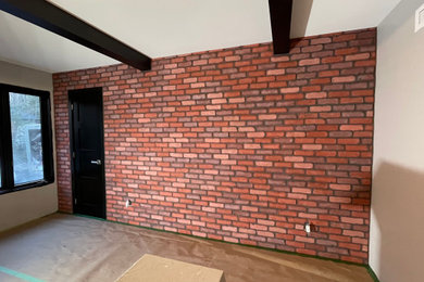 Urban master brick wall bedroom photo in Montreal with red walls