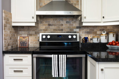 Large transitional u-shaped ceramic tile enclosed kitchen photo in Toronto with an undermount sink, shaker cabinets, white cabinets, stainless steel appliances, a peninsula, granite countertops, beige backsplash and brick backsplash