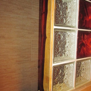 Cocobolo wood trim around decorative glass block wall in a shower