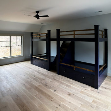 Spacious Shared Kids Room with Custom Bunk Beds, Integrated Drawers, and Vaulted