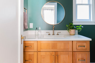 Small mid-century modern 3/4 marble floor, multicolored floor and single-sink bathroom photo in New York with shaker cabinets, light wood cabinets, a two-piece toilet, an undermount sink, quartz countertops, white countertops and a built-in vanity