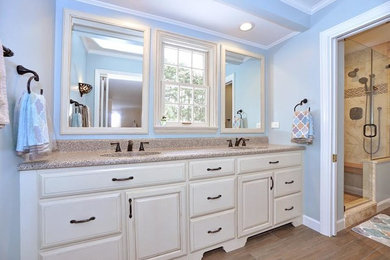 This is an example of a mid-sized transitional master bathroom in Other with recessed-panel cabinets, medium wood cabinets, an open shower, a two-piece toilet, green walls, medium hardwood floors, a drop-in sink and granite benchtops.