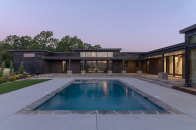 Huge minimalist brown one-story wood exterior home photo in Other