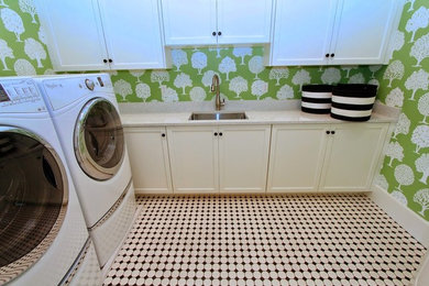 Mid-sized country l-shaped dedicated laundry room in Salt Lake City with an undermount sink, recessed-panel cabinets, white cabinets, quartz benchtops, green walls, porcelain floors and a side-by-side washer and dryer.