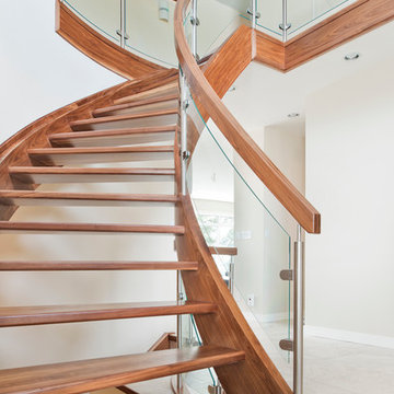 Curved Walnut Stair With Curved Glass