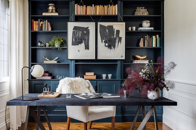 Inspiration for a transitional freestanding desk medium tone wood floor study room remodel in Providence with white walls