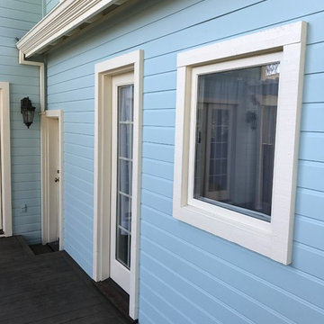 Exterior side view of window and door with terra blue paint