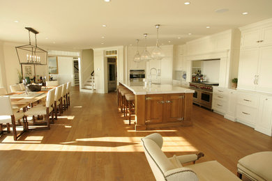 Eat-in kitchen photo in Bridgeport with white cabinets and white backsplash