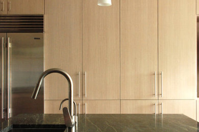 Kitchen - mid-sized contemporary l-shaped dark wood floor and brown floor kitchen idea in Chicago with an undermount sink, flat-panel cabinets, light wood cabinets, quartzite countertops, white backsplash, subway tile backsplash, stainless steel appliances, an island and green countertops