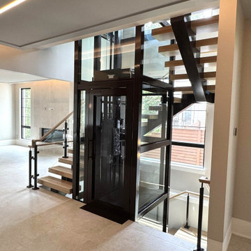 Project #136 | Modern Floating Staircase Encircling Glass Elevator
