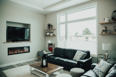 Living room - mid-sized industrial open concept vinyl floor living room idea in Vancouver with gray walls, a hanging fireplace and a media wall