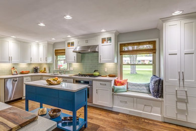 Large trendy u-shaped dark wood floor enclosed kitchen photo in Other with an undermount sink, shaker cabinets, white cabinets, soapstone countertops, green backsplash, subway tile backsplash, stainless steel appliances and two islands