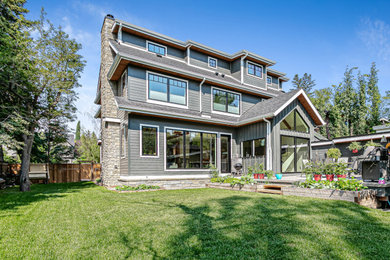 Large craftsman three-story concrete fiberboard house exterior idea in Calgary