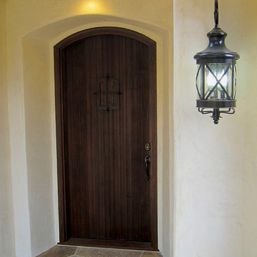Small Spanish Style Cottage Front Door with Speakeasy and iron grille