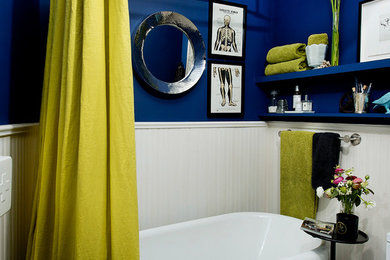 Inspiration for a small contemporary claw-foot bathtub remodel in Montreal with open cabinets and blue walls