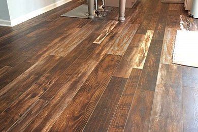 Example of a small southwest galley vinyl floor eat-in kitchen design in Raleigh with recessed-panel cabinets, white cabinets, an island, granite countertops and stainless steel appliances