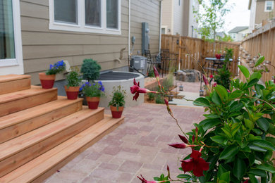 Photo of a small backyard brick landscaping in Denver with a fire pit.