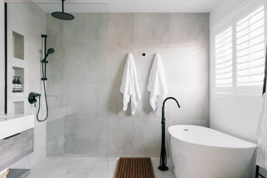 Example of a mid-sized danish master gray tile and porcelain tile porcelain tile, gray floor and double-sink bathroom design in Toronto with flat-panel cabinets, light wood cabinets, white walls, an undermount sink, quartzite countertops, white countertops, a niche and a floating vanity