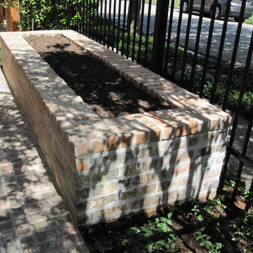 High function in a small side yard! Pergola, raised bed, mirrored wall, fountain