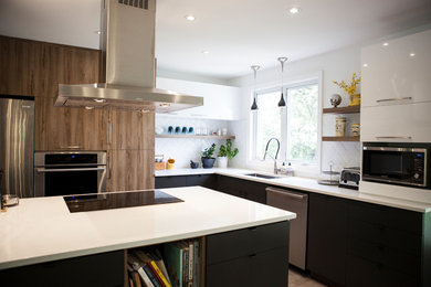 Photo of a mid-sized contemporary l-shaped eat-in kitchen in Other with an undermount sink, flat-panel cabinets, dark wood cabinets, quartzite benchtops, white splashback, ceramic splashback, stainless steel appliances, ceramic floors, with island and grey floor.