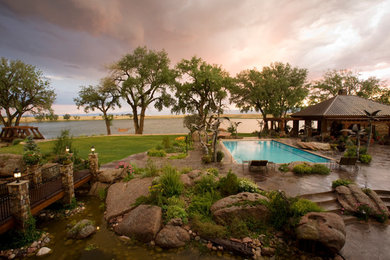Design ideas for an eclectic backyard water fountain landscape in Denver.