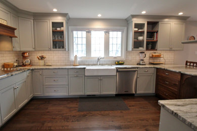 Example of a transitional u-shaped kitchen design in Other with gray cabinets, granite countertops, subway tile backsplash, stainless steel appliances and multicolored countertops