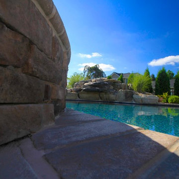 Custom Freeform style salt water in ground pool with Pool House and Raised Spa