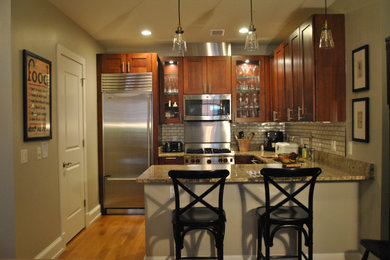 Eat-in kitchen - small transitional u-shaped medium tone wood floor and brown floor eat-in kitchen idea in DC Metro with an undermount sink, shaker cabinets, medium tone wood cabinets, granite countertops, beige backsplash, ceramic backsplash, stainless steel appliances, a peninsula and brown countertops