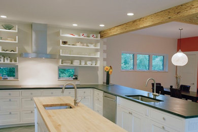 Enclosed kitchen - mid-sized transitional u-shaped light wood floor enclosed kitchen idea in Boston with an undermount sink, shaker cabinets, white cabinets, stainless steel appliances and an island